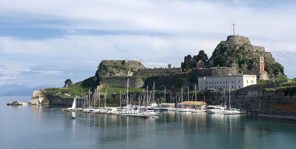 A view over water of The Old Fortress, Corfu